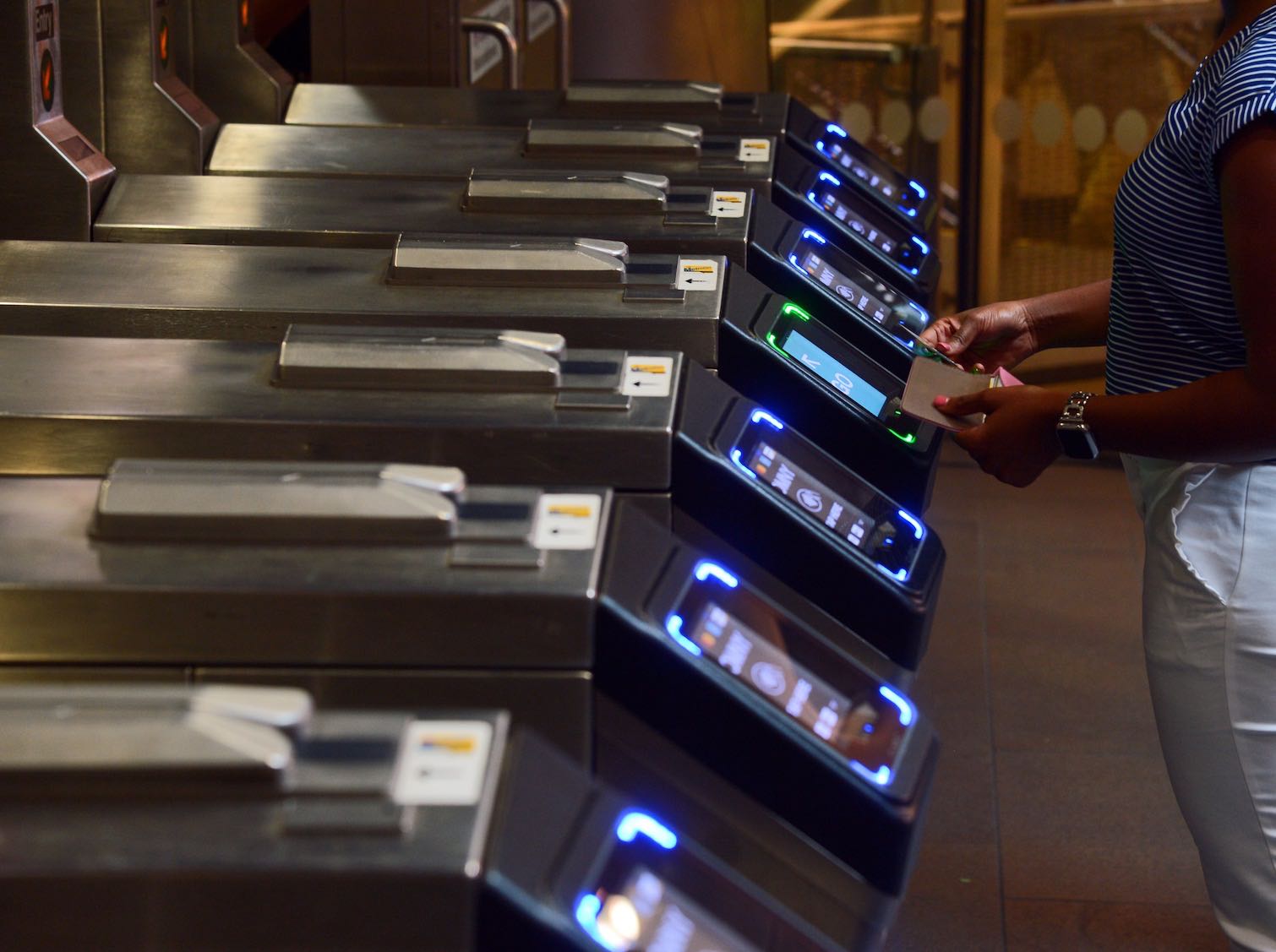 Row of OMNY readers installed in a subway platform